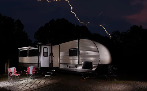Caravan with lightning in background