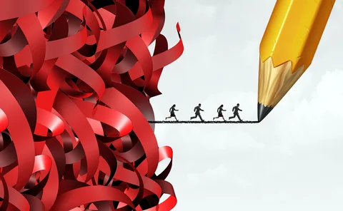 Employees running from red tape on pencil - concept