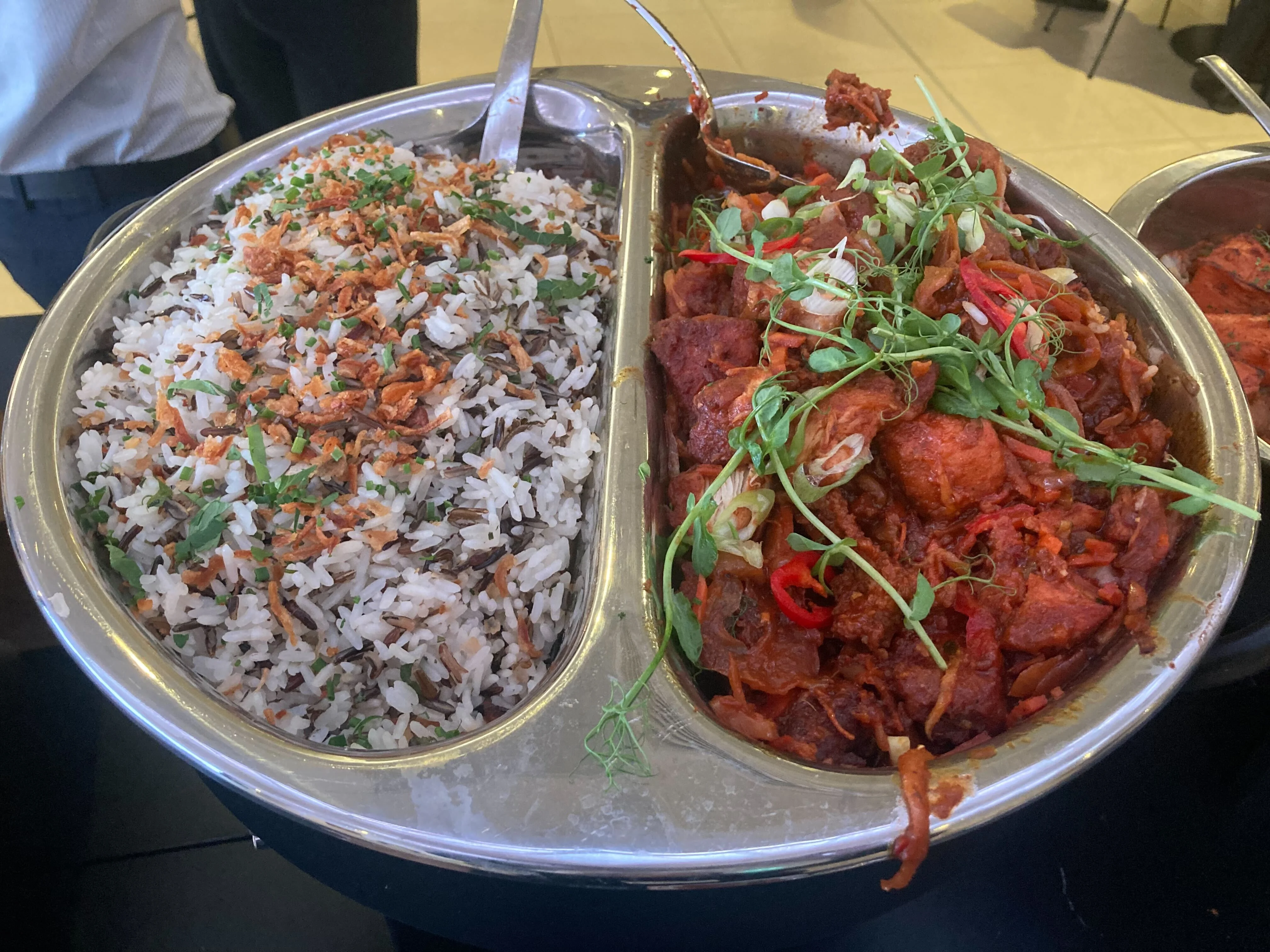 Metal two-compartment dish with rice and five-spice and ginger chilli glazed chicken.