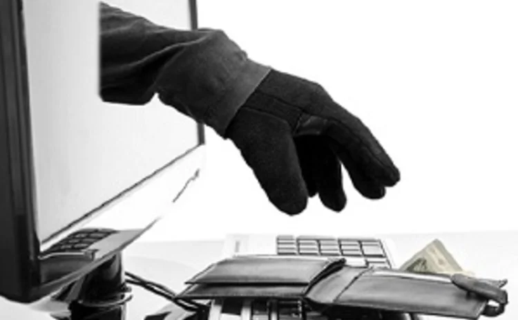 Gloved hand emerging from monitor